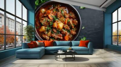 A warming beef stew served in a black bowl, featuring tender beef chunks, carrots, beans, and rich, savory broth, garnished with fresh parsley on a dark tabletop. Wall mural