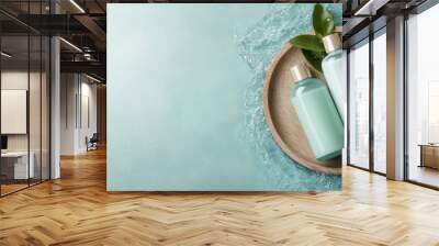 Aesthetic arrangement of two mint-colored bottles accompanied by fresh leaves and set on a textured wooden tray, surrounded by water flowing for a refreshing look. Wall mural