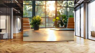 Sunlight fills a modern office space, with green plants and comfortable orange chairs around a wooden table, creating a tranquil and inviting atmosphere for meetings. Wall mural