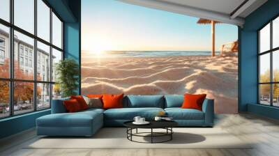 Sunlit sandy beach stretches to a shimmering ocean, framed by a wooden canopy, capturing the serene beauty of a summer afternoon seaside landscape. Wall mural