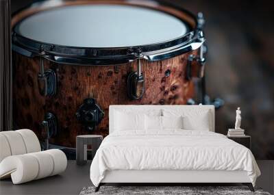 This image features a wooden snare drum, viewed from a side angle, emphasizing the intricate details of its texture and chrome fittings, presented on a dark background. Wall mural