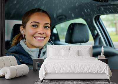 Rainy Day Drive A woman with a warm smile wearing earbuds drivin Wall mural