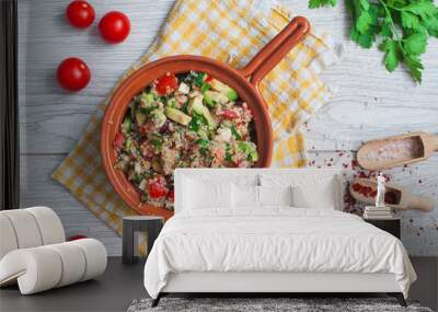 Delicious quinoa salad with avocado, cucumber and tomatoes on a rustic wooden table. Superfoods concept. Selective focus. View from above. Wall mural