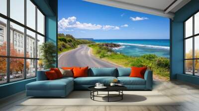 A road with a beautiful ocean view in the background. The road is empty and the sky is clear Wall mural