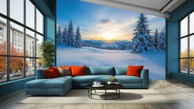 A snowy field with trees in the background and a beautiful sunset in the sky. The scene is peaceful and serene, with the sun setting behind the trees, casting a warm glow over the snow Wall mural