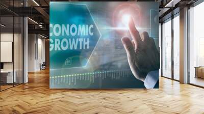 A businessman controlling a futuristic display with a Economic Growth business concept on it. Wall mural