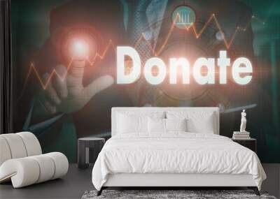 A businessman operating a computer display with a Donate business word concept on it. Wall mural