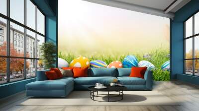 A collection of painted easter eggs celebrating a Happy Easter on a spring day with green grass meadow background with copy space. Wall mural