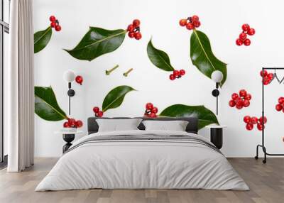 A collection of small smooth holly leaves with red berries for Christmas decoration isolated against a transparent background. Wall mural