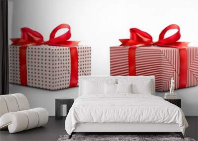 A collection of white and red gift wrapped Christmas presents with red ribbon bows isolated against a transparent background. Wall mural