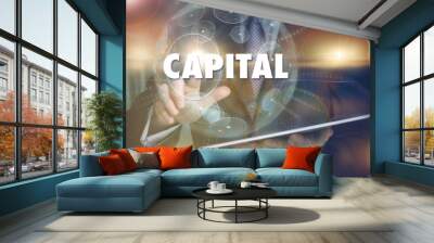 A hand selecting a Capital business concept on a futuristic computer display. Wall mural