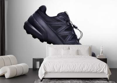 A side view of black trainers, sneakers Isolated on a flat background. Wall mural