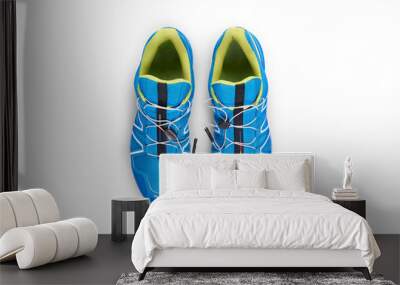 A top view of blue and yellow trainers, sneakers Isolated on a flat background. Wall mural