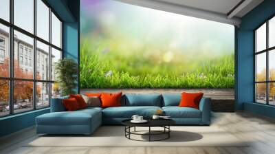 A wooden table product display with warm summer garden background of green grass and blurred foliage with strong sunlight. Wall mural