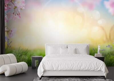 Pink cherry tree blossom flowers blooming in a green grass meadow on a spring Easter sunrise background. Wall mural