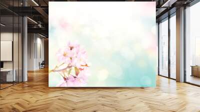 Pink cherry tree blossom flowers blooming in spring, easter time against a natural sunny blurred garden banner background of blue, yellow and white bokeh. Wall mural