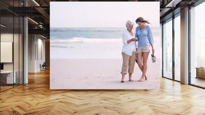 Discoveries with my daughter. Shot of a senior mother and her adult daughter exploring the beach. Wall mural