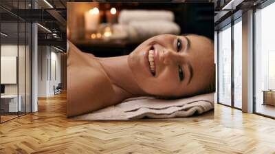 Happy, woman and portrait in spa with candles at night for luxury treatment in hotel on vacation. Girl, relax and smile on table for cosmetics, skincare and holiday at resort for beauty and wellness Wall mural