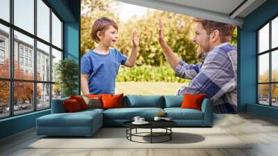 High five, kid and man in park for family adventure, support and motivation with development. Dad, boy child and happy with excited hand gesture for success, teamwork and happiness together in garden Wall mural