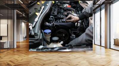 Close up hands of auto mechanic doing car service and maintenance. Services car engine machine. Wall mural