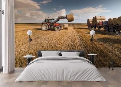 Bale on tractor trailer in farm field Wall mural