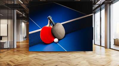 ping pong rackets and balls on a blue table with net. Wall mural