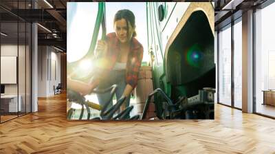 female junior driver checks the truck's equipment, practices safe driving and follows safety precautions set for cargo trucks Wall mural