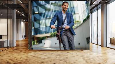 men in 30's in suit with electric scooter and a laptop bag going on his job. city environment. ecological transportation concept. Wall mural