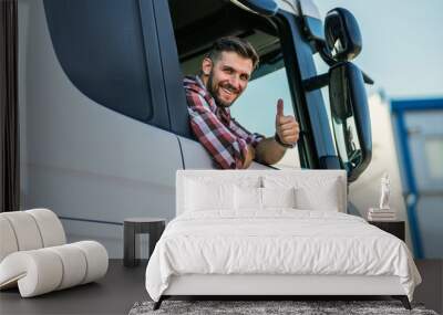 Truck driver sitting in his truck showing thumbs up. Trucker occupation. transportation services. Wall mural