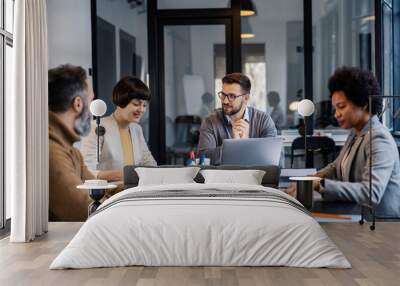 A chief sitting with his interracial coworkers and having briefing. Wall mural