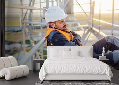 A metal construction worker sleeping on his workplace. Wall mural