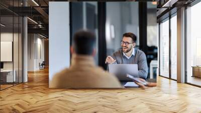 A multiracial team is sitting at the boardroom and having briefing at the corporate company. Wall mural