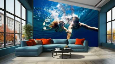 Cheerful couple having fun underwater and making selfie. Wall mural