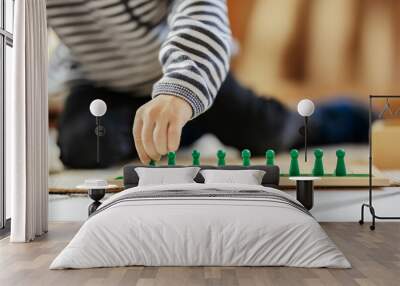 Close up of a little boy playing with educational toy at montessori kindergarten. Wall mural