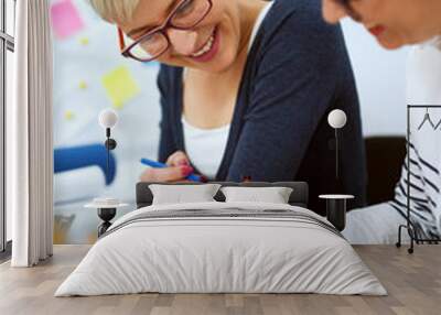 Close up of two smiling innovative stylish business middle aged women working together on problem solving while sitting in the office one next to another. Wall mural