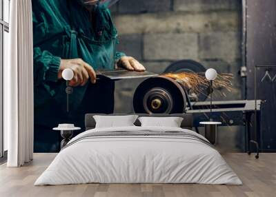 Cropped picture of cutler sharpening blade on grindstone in his workshop. Wall mural