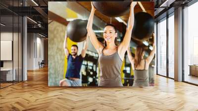 Exercising at gym with pilates ball. Wall mural