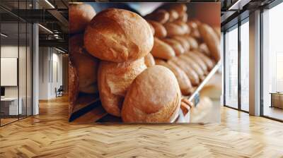 Fresh delicious loafs of bread in row on shelves ready for sale. Bakery interior. Wall mural