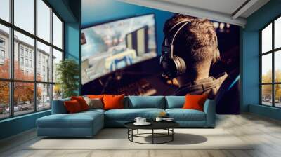 Rear view of professional gamer finishing mission on video game at gaming room. Wall mural