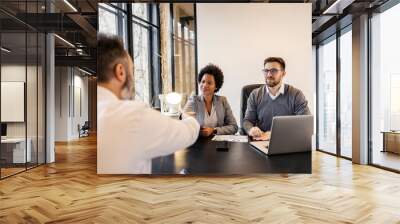 Successful partnership. Interracial businesspeople shaking hands after job interview. Wall mural