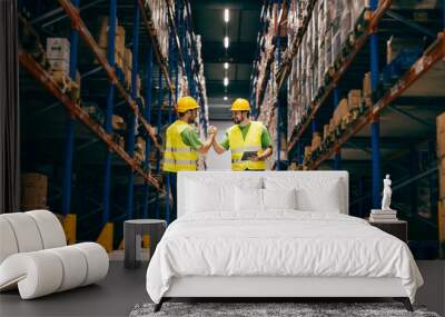 Two storage workers having bro handshake. Wall mural