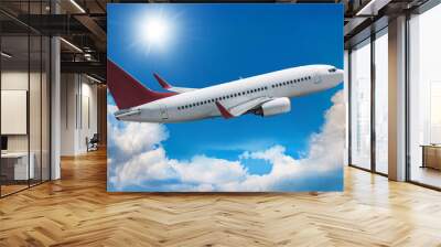 Passenger airliner flies in the air above picturesque clouds Wall mural