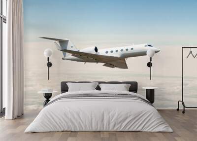 White luxury private jet flying in the air above the clouds Wall mural