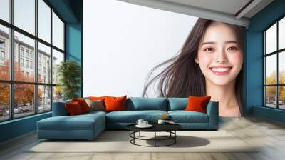 A joyful Japanese woman with long hair smiles brightly, radiating happiness. Wall mural