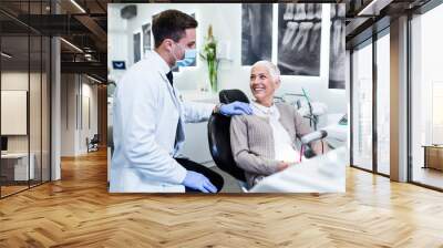 Beautiful senior woman receiving a dental treatment. Wall mural