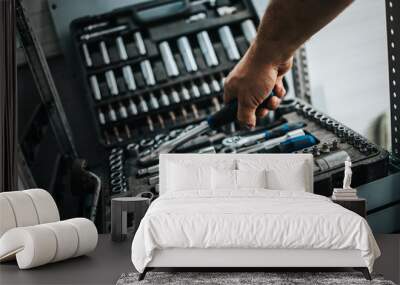 Close up shot of worker hand taking some professional tools from toolbox Wall mural