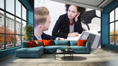 Multiracial business man and woman working together in modern office. Wall mural