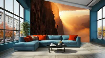 A lone hiker on a mountain peak at sunset Wall mural