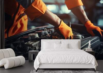 Black mechanic wearing orange coveralls fixing a car engine Wall mural