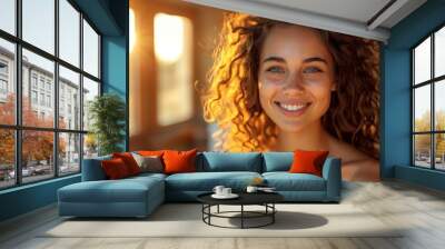 portrait of a beautiful young woman with curly hair smiling Wall mural